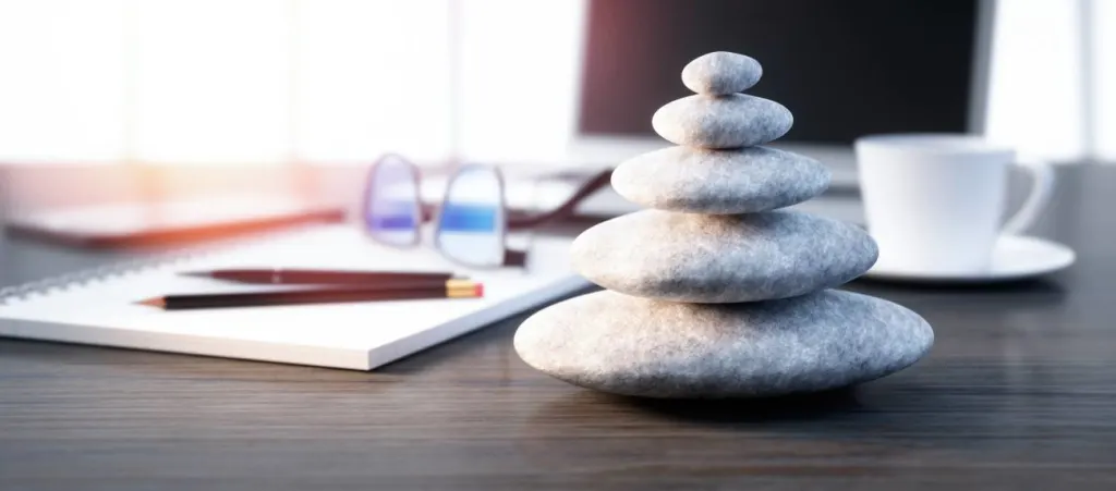 Stack of pebbles on a workplace desktop